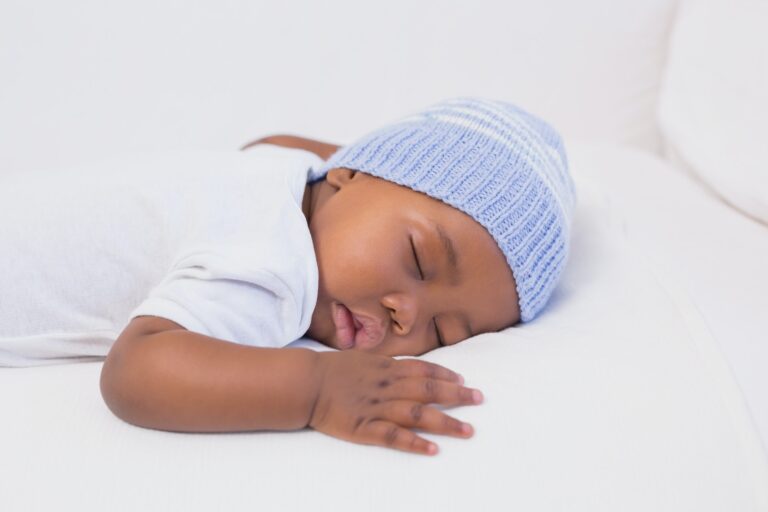 Adorable baby boy sleeping peacefully at home in the living room